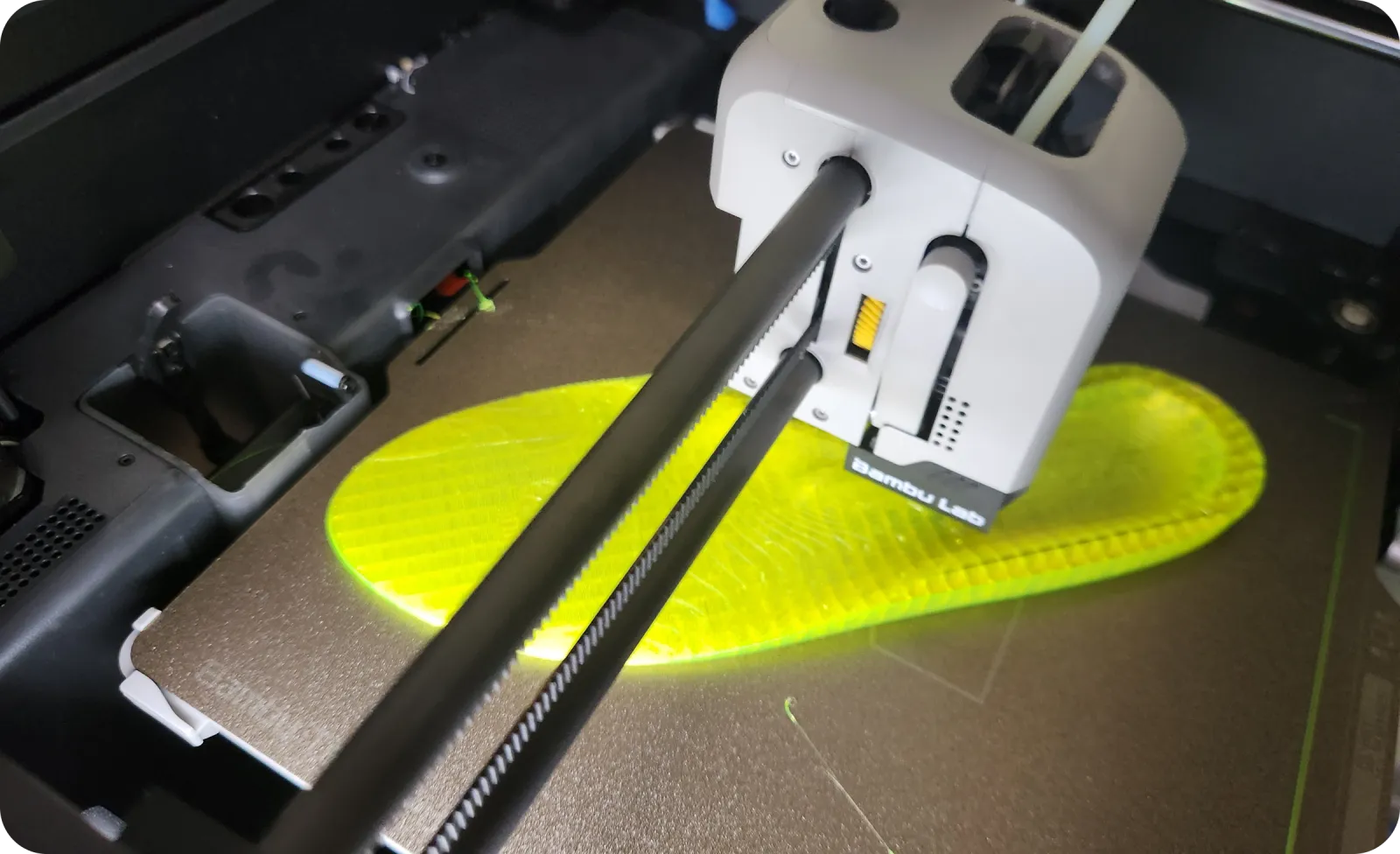 A flexible yellow Ergono3D insole being printed in TPU on a desktop 3D printer
